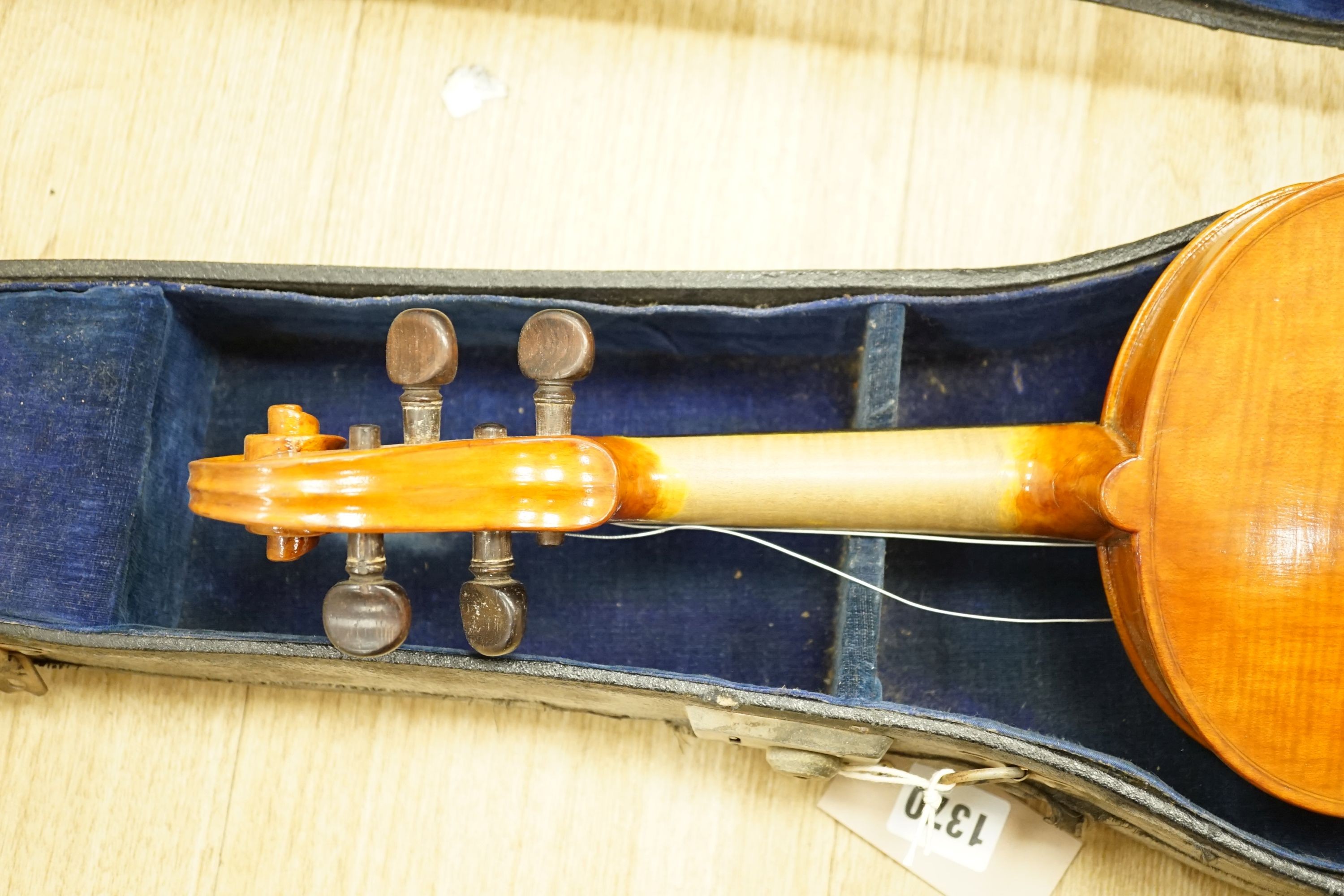 A cased violin, 60 cms long.